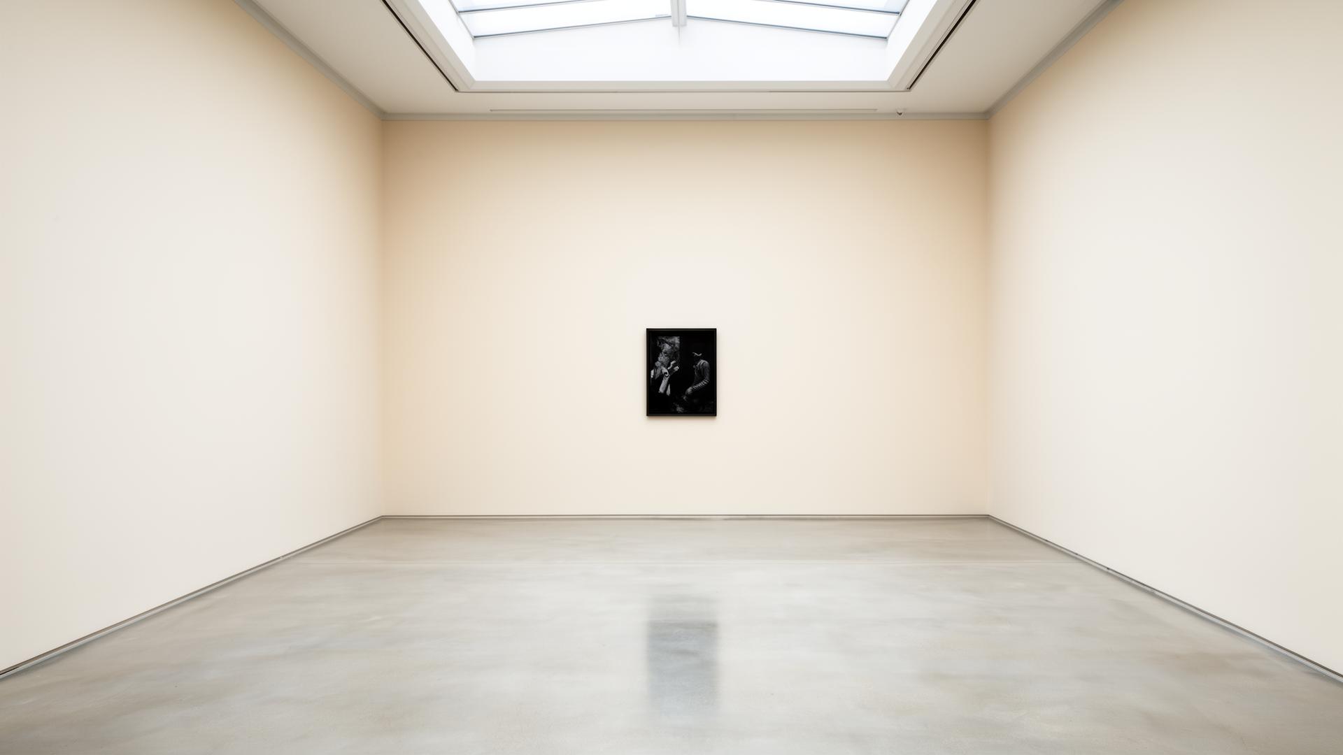 Empty contemporary gallery exhibition room with a single artwork